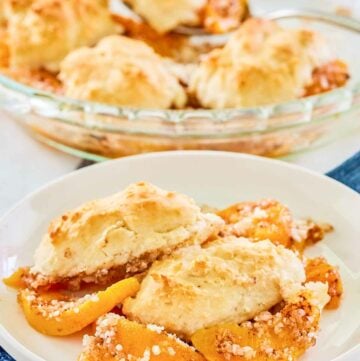 Bisquick peach cobbler on a plate and in a pie plate.