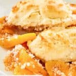 Closeup of Bisquick peach cobbler on a white plate.