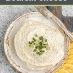 Overhead view of homemade boursin cheese spread on a plate and crackers next to it.