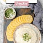 Overhead view of homemade boursin cheese spread and crackers on a board.
