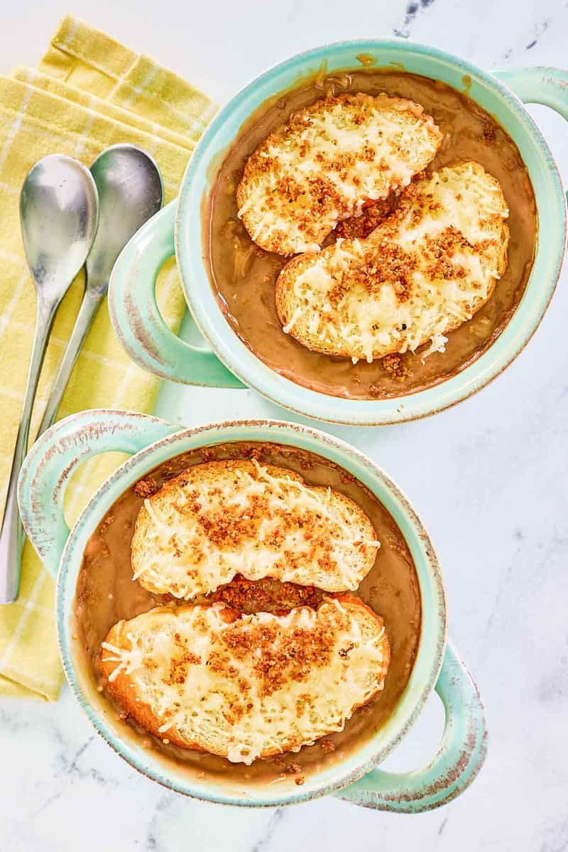 Overhead view of copycat Brennan's French onion soup in two soup crocks.