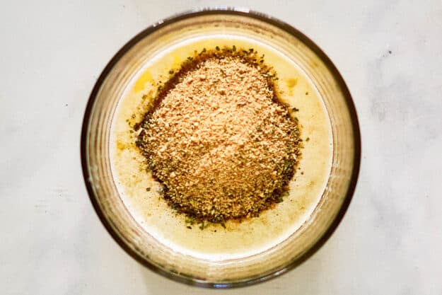 Bread crumbs and melted butter in a bowl.