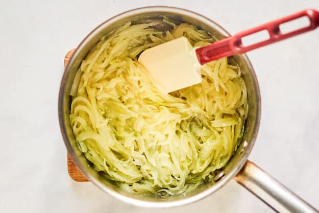Cooked onion slices in a pan.