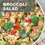 Overhead view of homemade broccoli salad in a big white bowl.