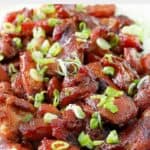 Homemade Cajun Cafe bourbon chicken garnished with green onions.