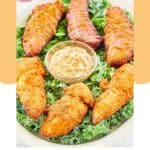 Captain Crunch chicken tenders and a bowl of Creole mustard on a platter.