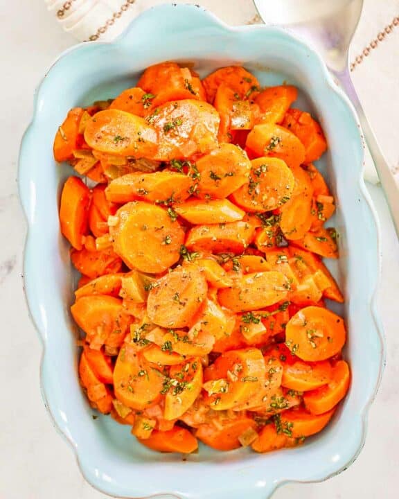 Overhead view of copper penny carrots in a serving dish.
