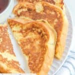 Overhead view of homemade Cracker Barrel French toast on a white plate.