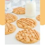 Homemade Crumbl ultimate peanut butter cookies and a glass of milk.