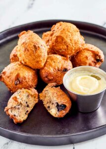 Copycat Denny's blueberry pancake puppies and cheesecake dip on a plate.