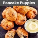 Homemade Denny's blueberry pancake puppies and sweet cream cheese dipping sauce on a plate.