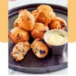 Homemade Denny's blueberry pancake puppies and cheesecake dipping sauce on a plate.