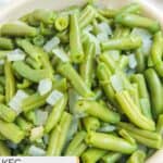 Closeup of homemade KFC green beans in a white bowl.