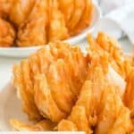 Two homemade Outback bloomin onions on plates.