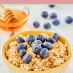 A bowl of overnight oats made with milk topped with fresh blueberries and honey.