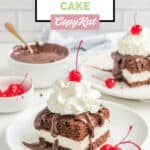 Homemade Shoney's Hot Fudge Cake on two plates and hot fudge sauce in a bowl.