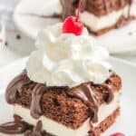 Closeup of homemade Shoney's hot fudge cake on a white plate.