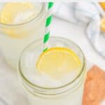 Homemade Starbucks lemonade in a mason jar with a lemon slice and colorful straw.