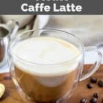 Homemade Starbucks Caffe latte with oat milk and coffee beans on a wood board.