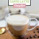 Homemade Starbucks oleato caffe latte and coffee beans scattered around it.