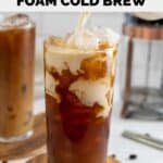 Pouring olive oil infused vanilla sweet cream foam into iced coffee.