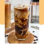 Homemade Starbucks Oleato golden foam cold brew coffee drink on a wood coaster.
