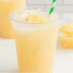 Homemade Starbucks paradise drink with a green and white striped straw.