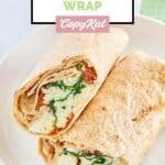 Homemade Starbucks spinach feta egg wrap cut in half and on a plate.