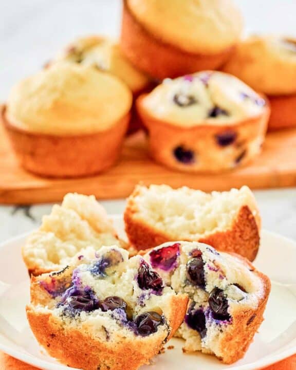 Blueberry and plain sweet muffins on a plate.