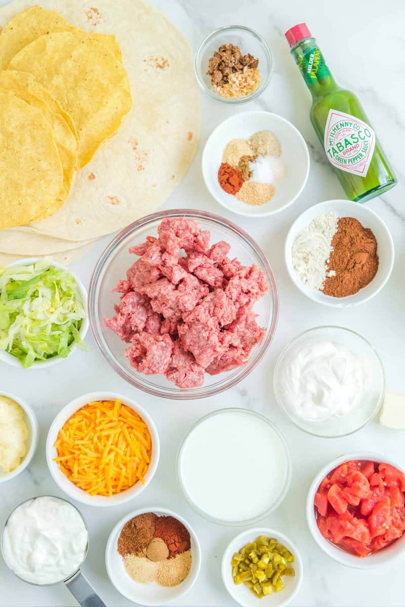 Copycat Taco Bell crunchwrap supreme ingredients on a marble surface.
