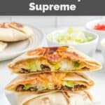 Homemade Taco Bell crunchwrap supreme on a marble surface.