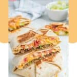 Homemade Taco Bell crunchwrap supreme stack with one cut in half.
