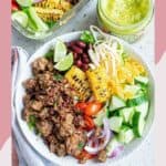 Overhead view of a taco bowl with ground beef and assorted toppings.