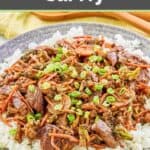 Teriyaki beef stir fry and white rice on a grey plate.
