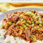 Teriyaki beef stir fry and rice on a grey plate.