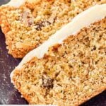 Closeup of two slices of zucchini bread with cream cheese frosting.