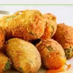 Deep fried cheddar cheese jalapeno poppers on a tan plate.