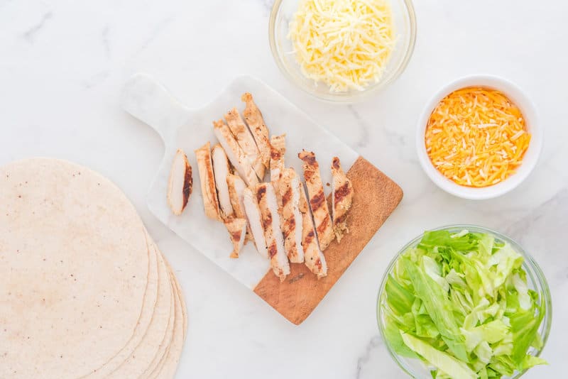 Copycat Chick Fil A cool wrap ingredients on a marble surface.