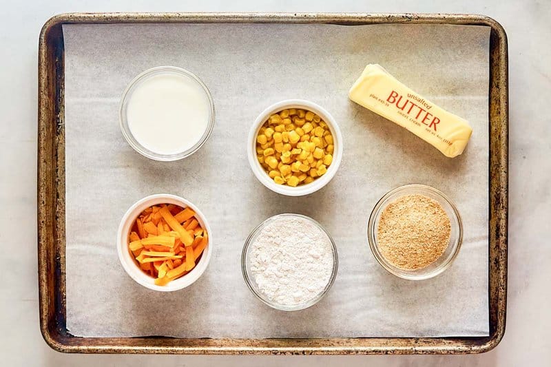 Corn au gratin ingredients on a tray.