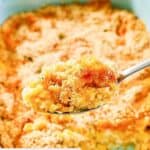 Corn au gratin on a spoon and in a baking dish.