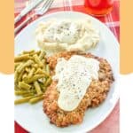 Copycat Cracker Barrel country fried steak dinner on a plate.