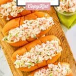 Overhead view of homemade imitation crab salad in hoagie rolls and a bowl.