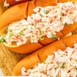 Overhead closeup of imitation crab salad in hoagie rolls.