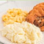 Homemade KFC mashed potatoes, mac and cheese, and fried chicken on a plate.