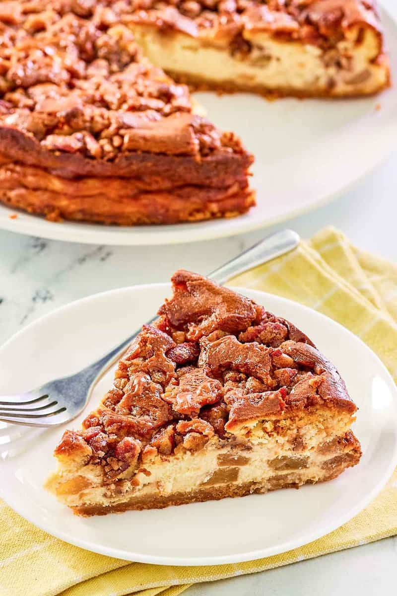 Copycat Olive Garden apple praline cheesecake slice and a fork on a plate.