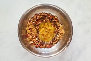 Apple praline cheesecake topping ingredients in a bowl.