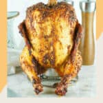 Smoked beer can chicken on a rack.