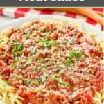Homemade spaghetti meat sauce on top of spaghetti pasta on a platter.