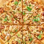 Overhead view of copycat California Pizza Kitchen Thai chicken pizza on a pizza peel.