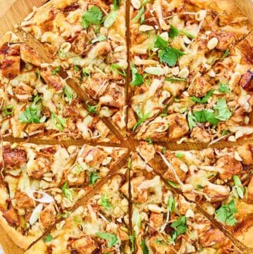Overhead view of copycat California Pizza Kitchen Thai chicken pizza on a pizza peel.